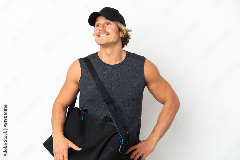 Young sport man with sport bag isolated on white background posing with arms at hip and smiling Young sport man with sport bag isolated on white background posing with arms at hip and smiling