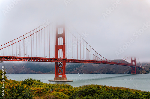Photography The famous Golden Gate bridge on a cloudy summer day with low hanging fog rollin