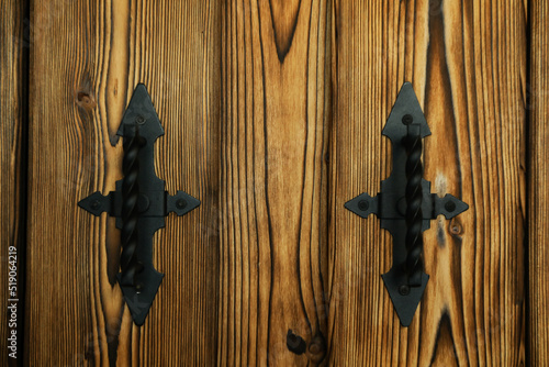 Old wooden doors with metal handles, close up