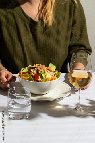 WOMAN EATING SALAD NICOISE