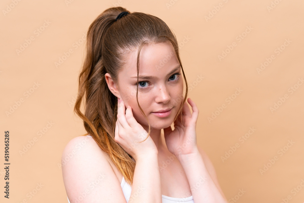Young caucasian girl isolated on beige background . Close up portrait Young caucasian girl isolated on beige background . Close up portrait