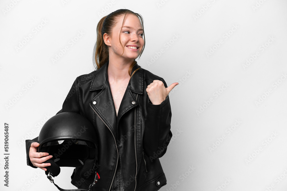 Young caucasian girl with a motorcycle helmet isolated on white background pointing to the side to present a product Young caucasian girl with a motorcycle helmet isolated on white background pointing to the side to present a product