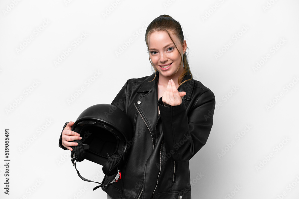 Young caucasian girl with a motorcycle helmet isolated on white background inviting to come with hand. Happy that you came Young caucasian girl with a motorcycle helmet isolated on white background inviting to come with hand. Happy that you came