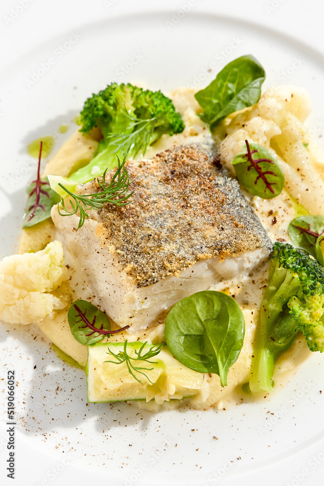 Roasted cod with mashed potatoes and broccoli. White fish fillet with skin with vegetables isolated on white background. Healthy food in restaurant menu. Fish and cabbages in minimalism style. Roasted cod with mashed potatoes and broccoli. White fish fillet with skin with vegetables isolated on white background. Healthy food in restaurant menu. Fish and cabbages in minimalism style.