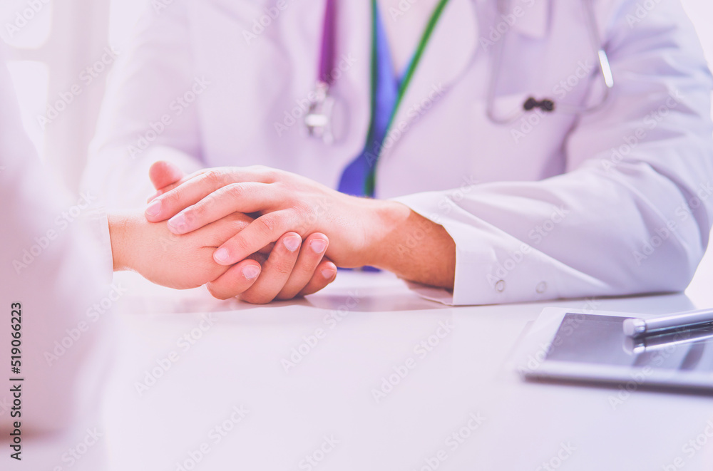 Close-up of stethoscope and paper on background of doctor and patient hands Close-up of stethoscope and paper on background of doctor and patient hands