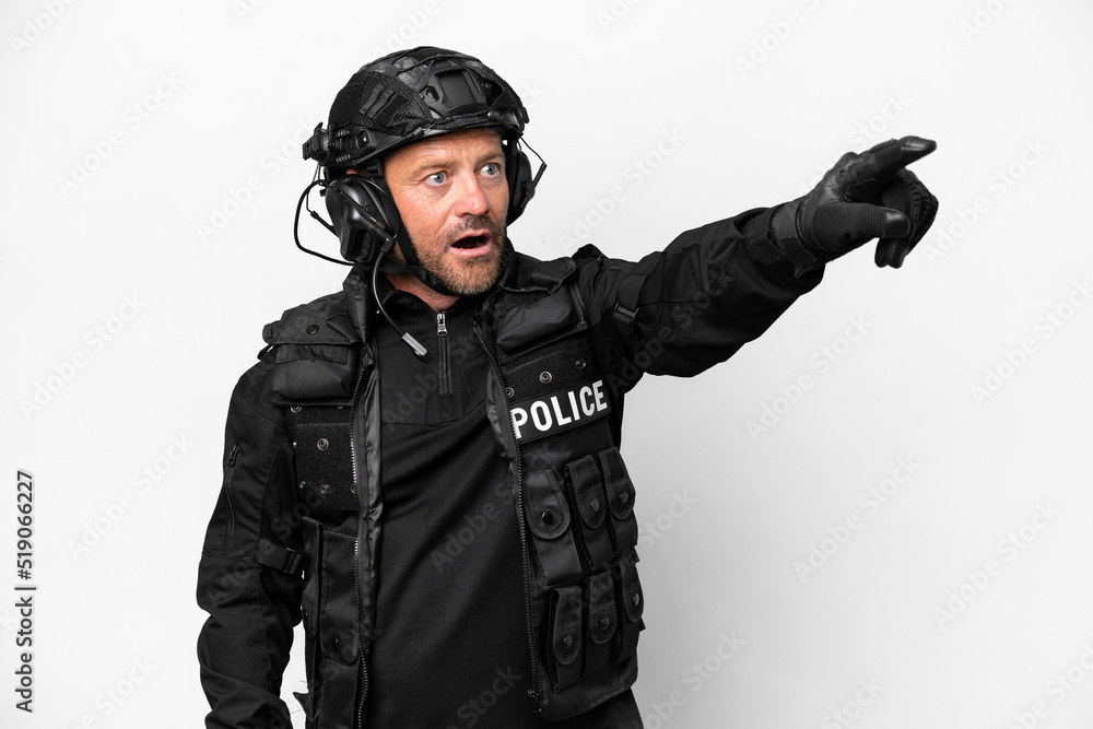 Middle age SWAT man isolated on white background pointing away Middle age SWAT man isolated on white background pointing away