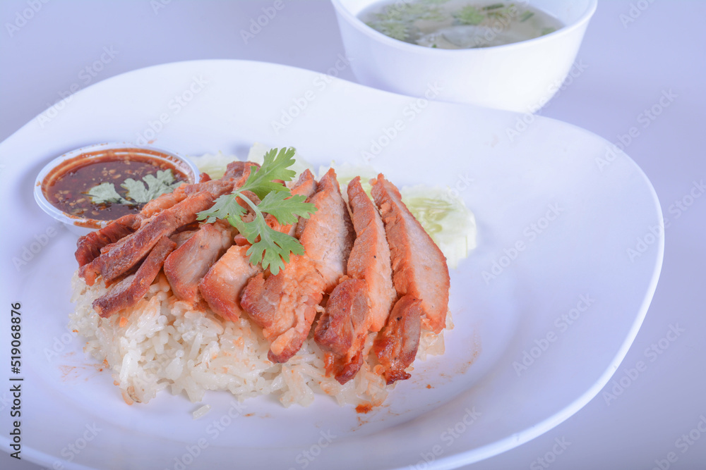 barbecued red pork in sweet sauce with rice and soup on white bowl for Thai food and isolate background barbecued red pork in sweet sauce with rice and soup on white bowl for Thai food and isolate background