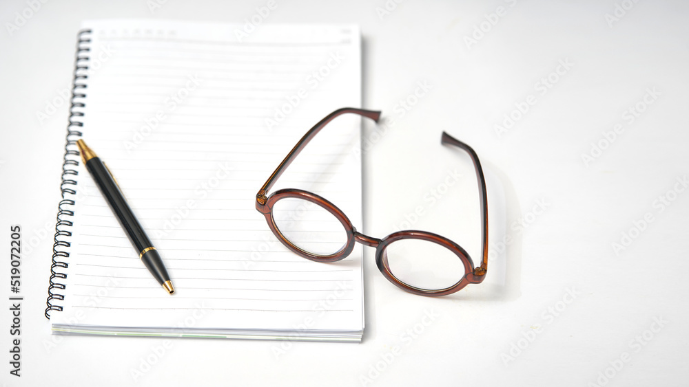 minimal notebook glasses and pen on white table minimal notebook glasses and pen on white table