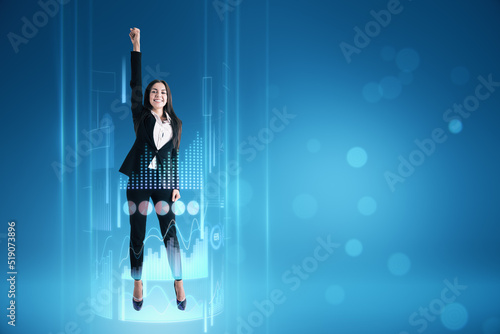 female surrounded with business chart hologram on blurry blue background with mock up place for your text or advertisement. Business boost up, success, future and start up concept. photo