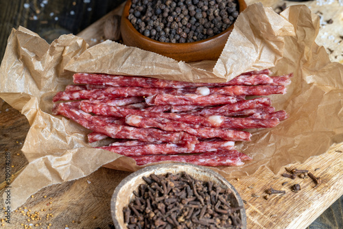 thin dried meat sausages with spices , close up © rsooll
