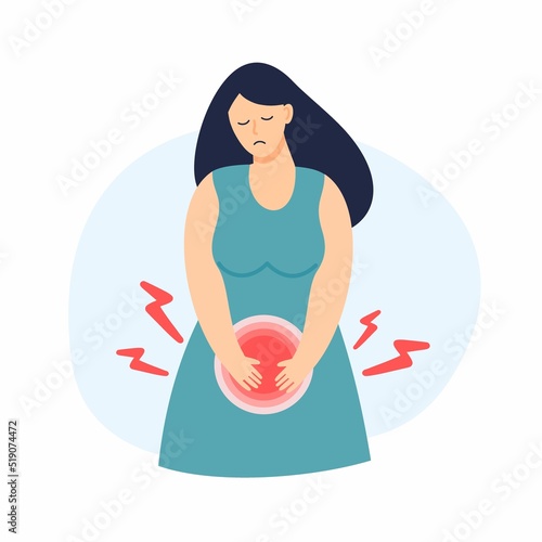 A sad girl with abdominal pain is holding her stomach. Menstruation, cystitis and other diseases in gynecology.