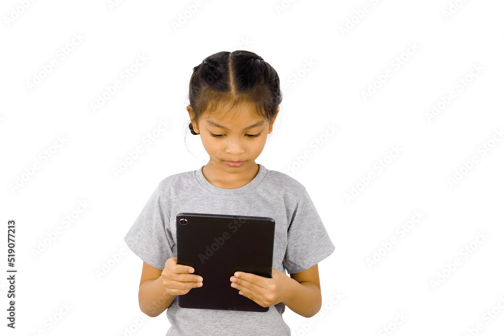 Little girl playing with a digital tablet isolated on white background. Little girl playing with a digital tablet isolated on white background.