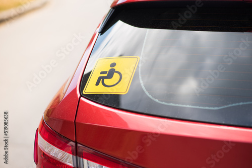 Wheelchair icon on the transport window. Disability badge on a red car.