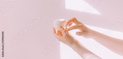 Women's hands hold a cosmetic copy space cream . An article about care cosmetics. Hand cream. © alenka2194