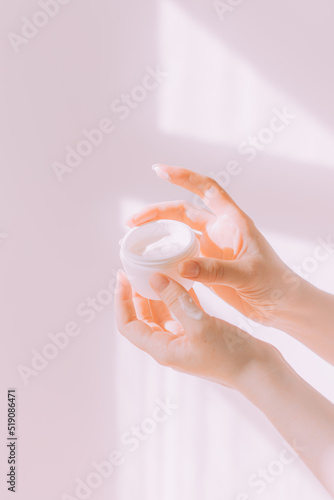 Women's hands hold a cosmetic copy space cream . An article about care cosmetics. Hand cream. © alenka2194