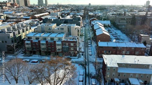 Housing in winter snowstorm. Urban city shutdown during pretty Christmas holiday snow. Flurries and flakes reflect in sunlight. photo