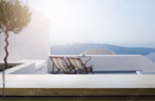 Art Empty wooden table on blurred background of sunny seaside patio.