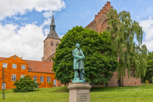 фотографія Monument for Hans Christian Andersen with Odense cathedral in background