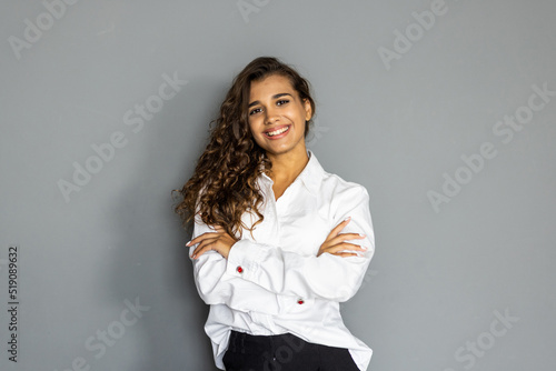Young business woman posing isolated over grey wall background.