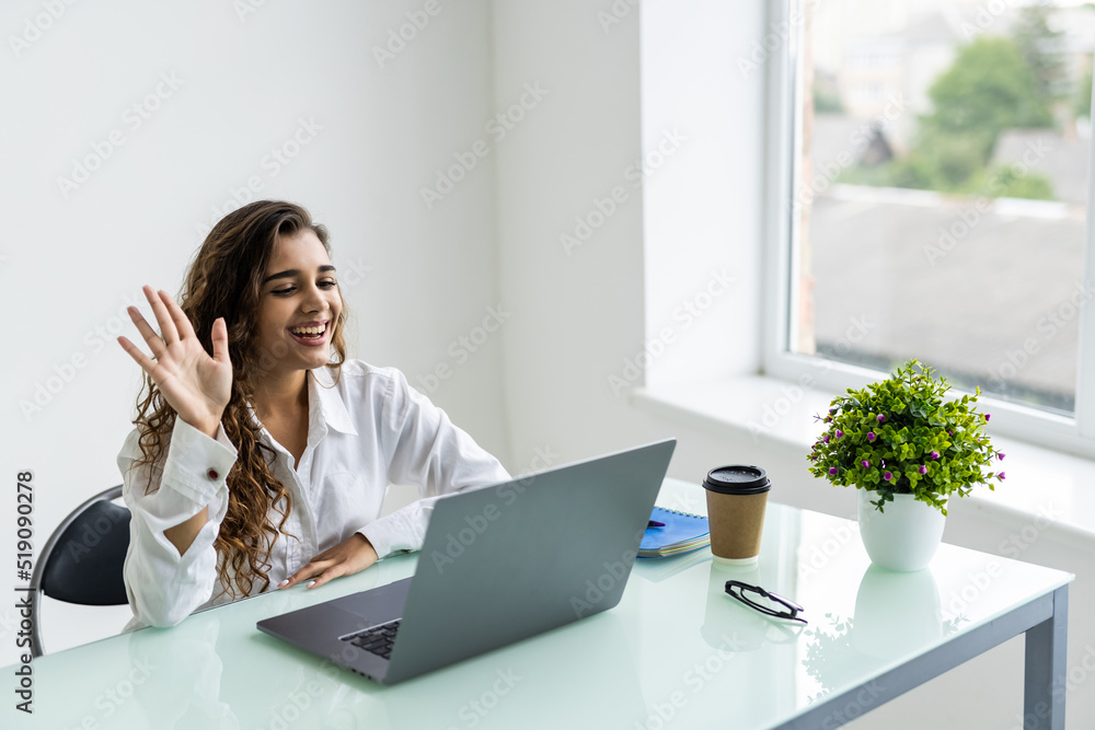 Young business woman having video call via laptop in the office Young business woman having video call via laptop in the office