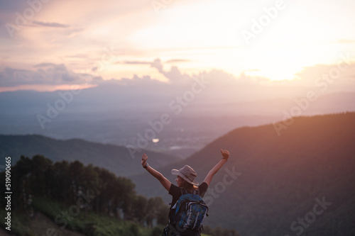 Happy woman with backpack hikes in the mountain with a beautiful view. Hikes mountain concept.