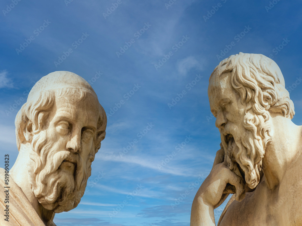 Plato and Socrates, the ancient Greek philosophers, with thoughtful expressions and blue sky with some clouds in the background. Marble statues, details.