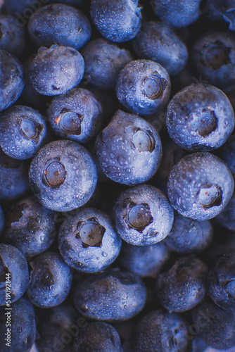 Fresh blueberries beautiful background. Blueberry texture close-up, top view. Fruits with dew drops