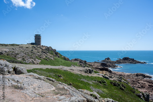 The iconic WW2 La Corbiere watchtower on the headland of St Brelade, Jersey, Channel Islands, British Isles.