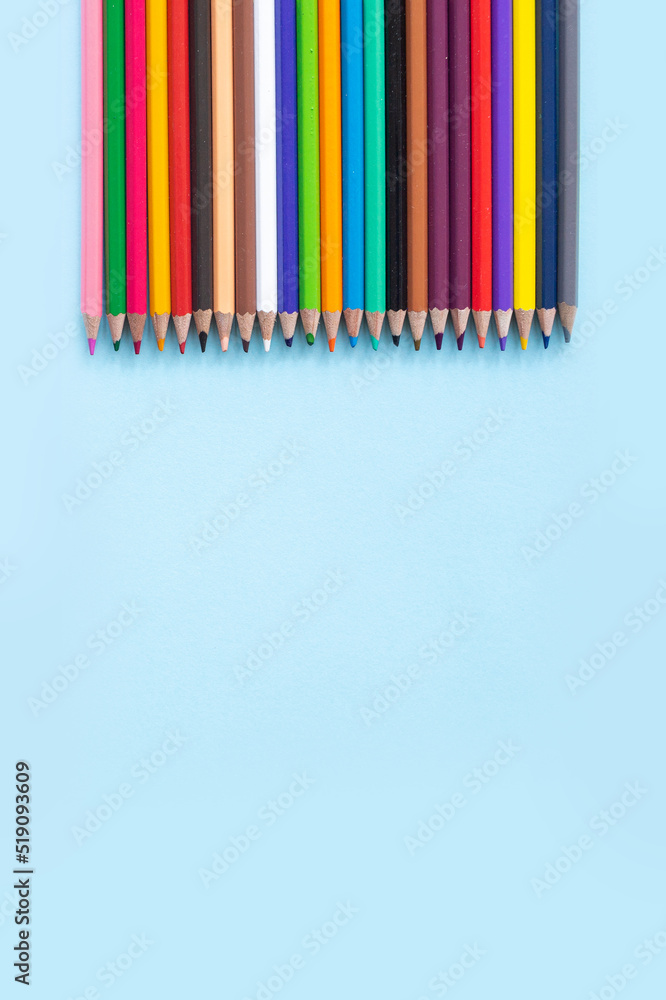 A set of bright stationery items on a blue background. Colour pencils A set of bright stationery items on a blue background. Colour pencils