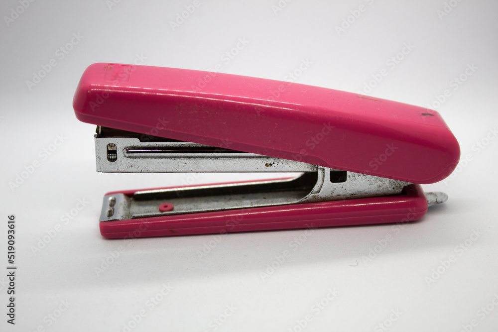 isolated pink stapler with selected focus on white background isolated pink stapler with selected focus on white background