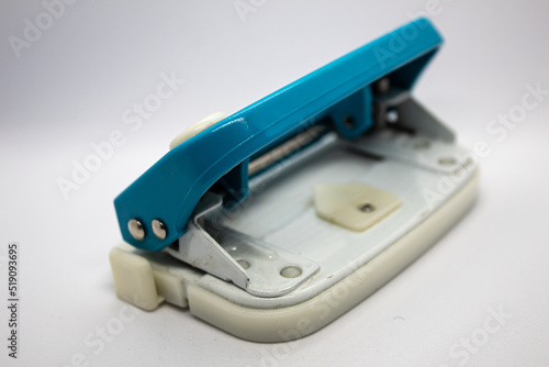 isolated selected focus blue white paper hole puncher on white background