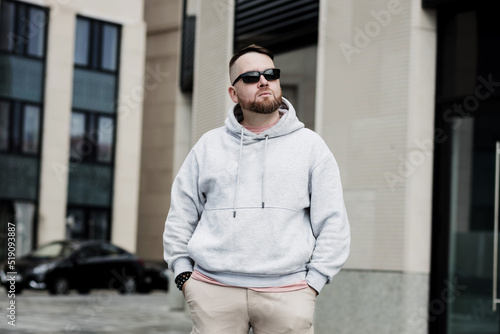 handsome man with beard wearing gray blank hoodie.