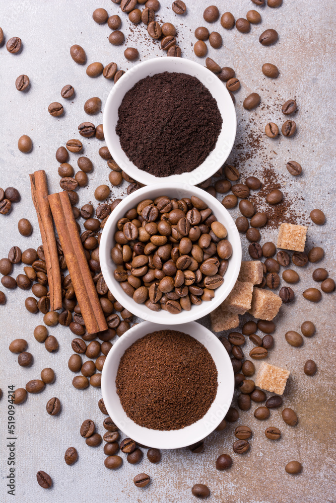 Roasted beans and different ground coffee with cinnamon and sugar for morning espresso Roasted beans and different ground coffee with cinnamon and sugar for morning espresso