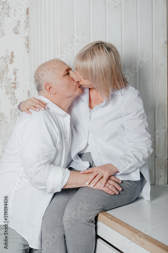 a man and his wife in white shirts in a photo studio photo