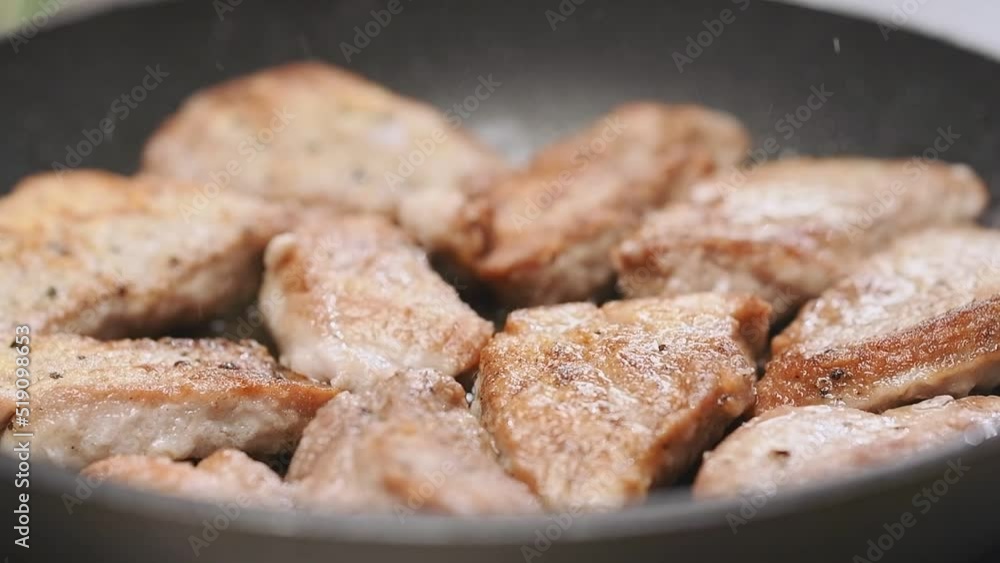Cooking of sliced pork tenderloin in a frying pan.
Cooking of sliced pork tenderloin in a frying pan.
