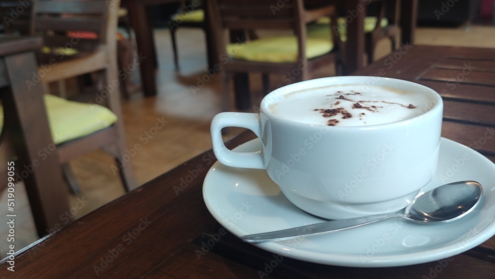 Fototapeta premium Hot milk coffee on wooden table.