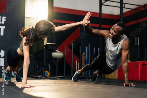 American African sportsman and Latino sportswoman workout in fitness.