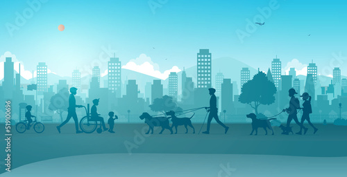 Husbands take their wives in wheelchairs and people take their dogs for a walk in the city park.