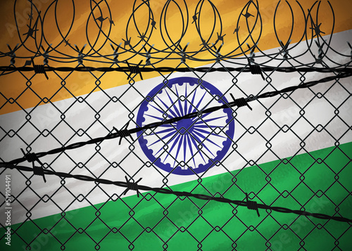 Indian flag behind barbed wire and metal fence