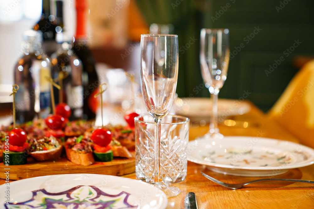 glasses, plates and sandwiches on the festive table. 