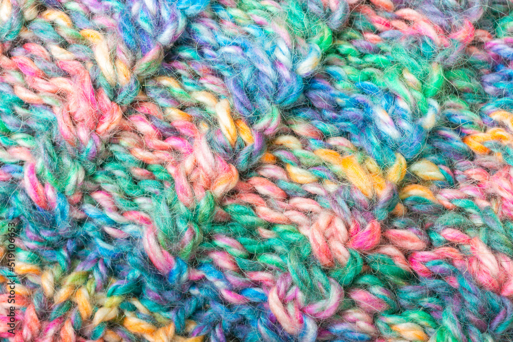 Knitted with colored woolen threads thing macro. Loops, pile, weaving