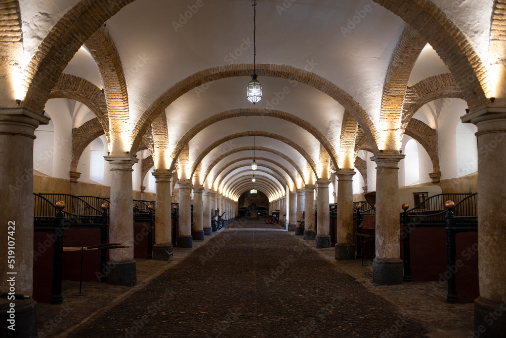 Arcade inside of the Royal Stables in Cordoba, Andalusia, Spain.