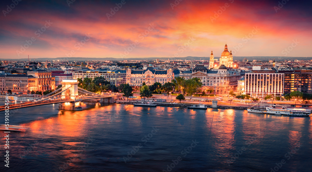 Illuminated evening cityscape of Budapest, capital of Hungary, Europe. Colorful summer view of Chain Bridge and St. Stephen's Basilica Church. Traveling concept background.