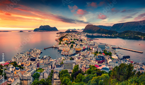 Obraz na płótnie Picturesque summer view from flying drone of Alesund port. Great sunset in west coast of Norway, at the entrance to the Geirangerfjord. Traveling concept background. w salonie