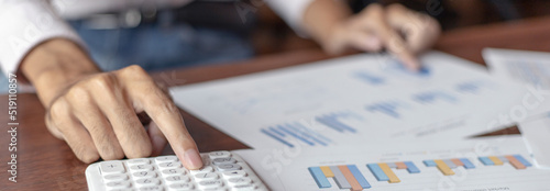 Business men analyze financial graphs and find break-even points for investments in order to reduce costs and reduce corporate taxes, Analysis of financial accounting and real estate investment.