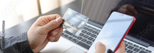 Business people hold a blue credit card and use computers as an intermediary for online payments, Online payment and internet communication concept.