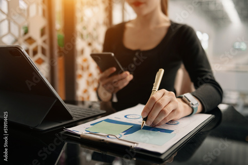 Businesswomen analyzing investment graph and discussing plan in office