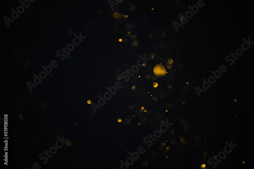 Few golden glitter bokeh sparkles shiny lights dark abstract overlay background