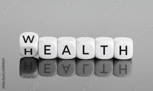 Wealth and Health concept. Flipping cube block with text