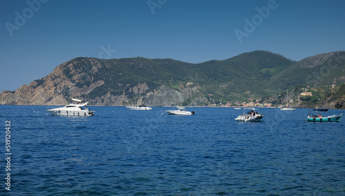 Travel to Cinque Terre. The beautiful Liguria Sea landscape with coast line harbour and a lot of boats. Blue water  and sky. Landmark of Italy. © Dragoș Asaftei